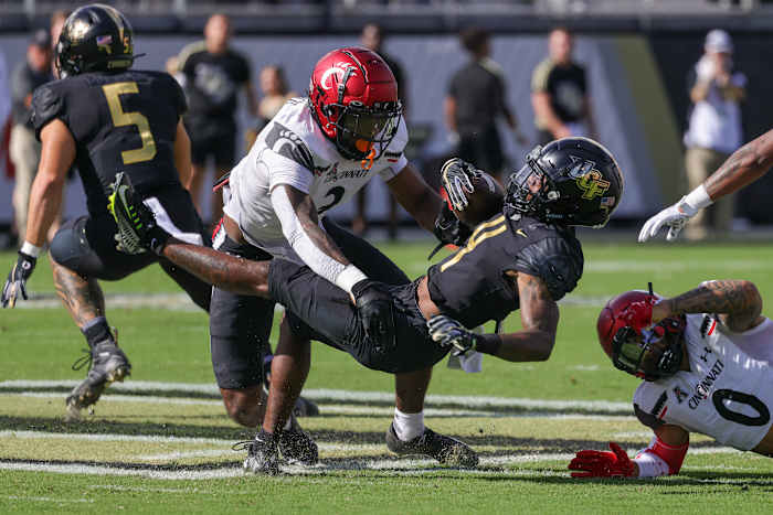 Oct 29, 2022; Orlando, Florida, USA; UCF Knights wide receiver Ryan O'Keefe (4) is tackled by Cincinnati Bearcats safety Ja'von Hicks (3) during the first quarter at FBC Mortgage Stadium. Mandatory Credit: Mike Watters-USA TODAY Sports